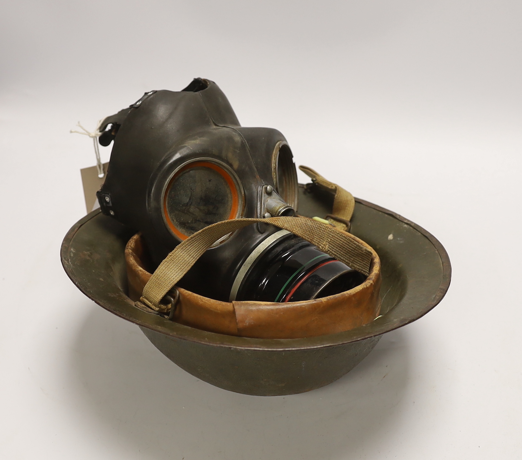 A WWII helmet and a gas mask